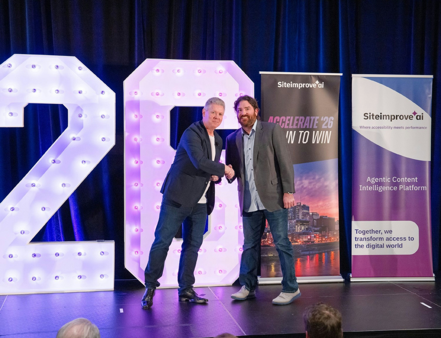 Chief Revenue Officer Gary Higgins congratulates an award winner at Siteimprove's Accelerate 2026 event.