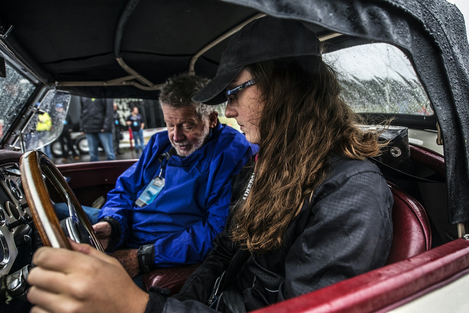 Team members work with instructors to teach young enthusiasts the basics of driving a manual transmission