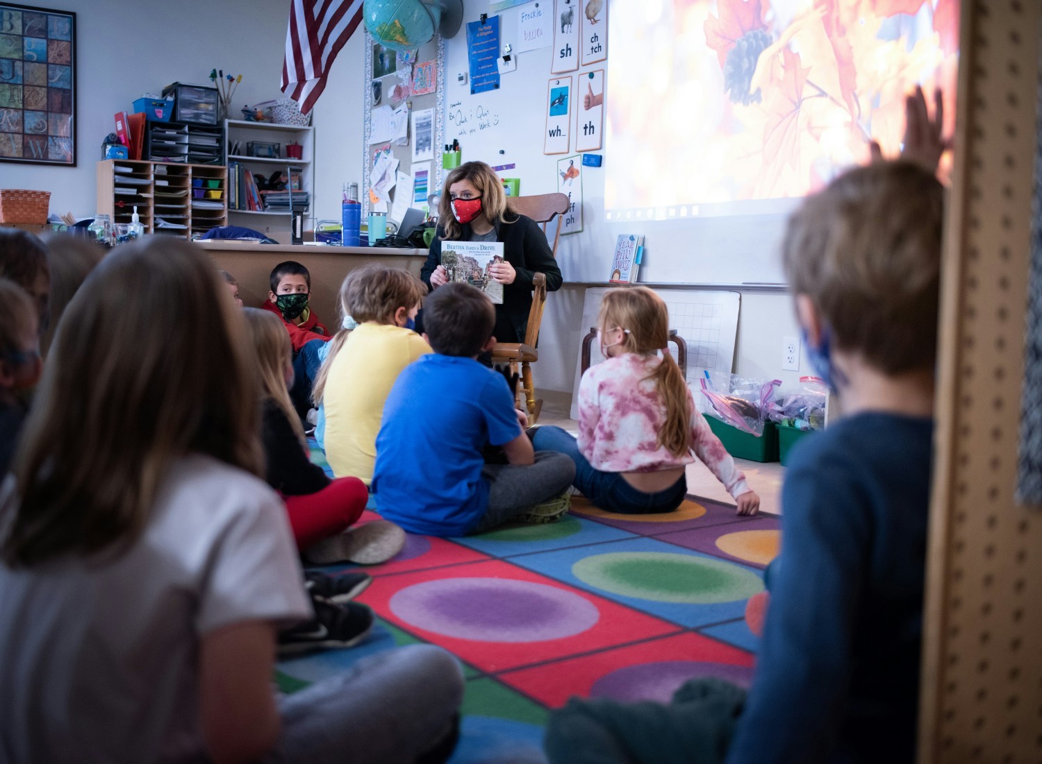 Team member reads to an elementary class. Hagerty donates an automotive themed book to local schools each year