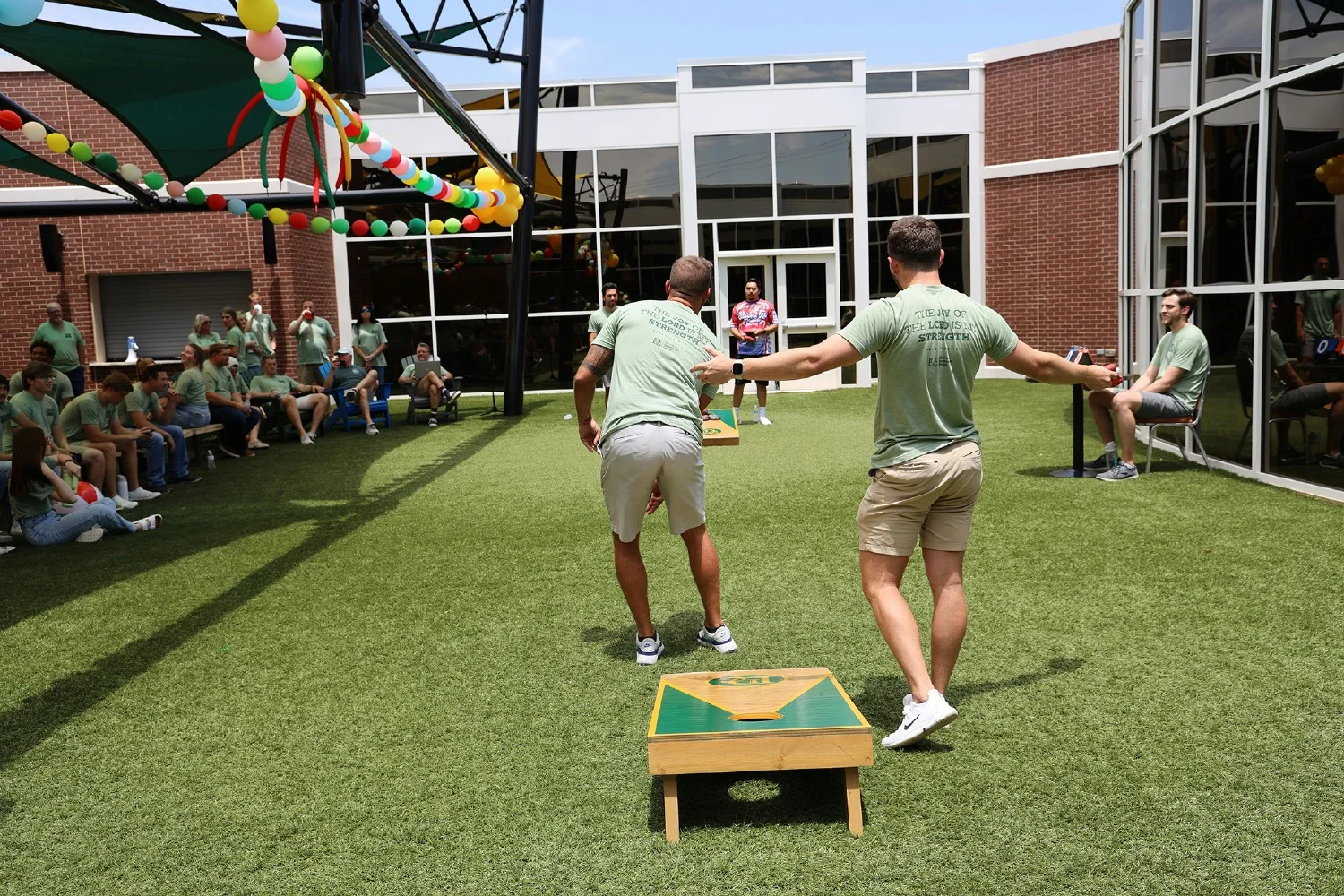 Employees compete in our annual cornhole tournament, showcasing teamwork and fun.