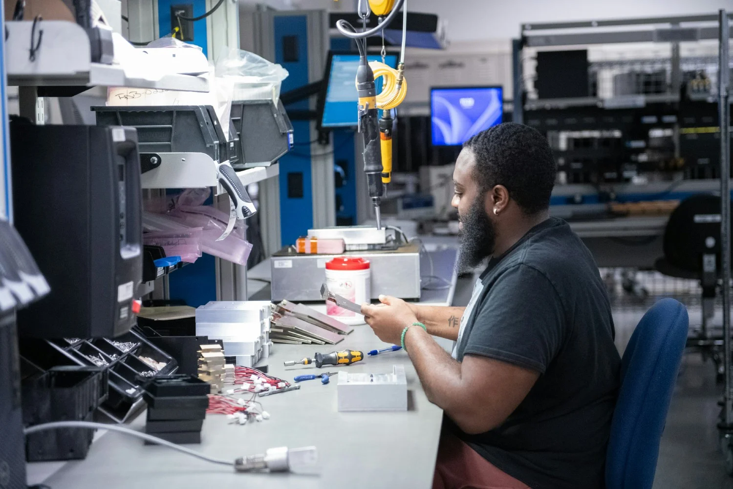 A team member works on a component for Hologic's 3D mammography system. Hologic invented 3D mammography.