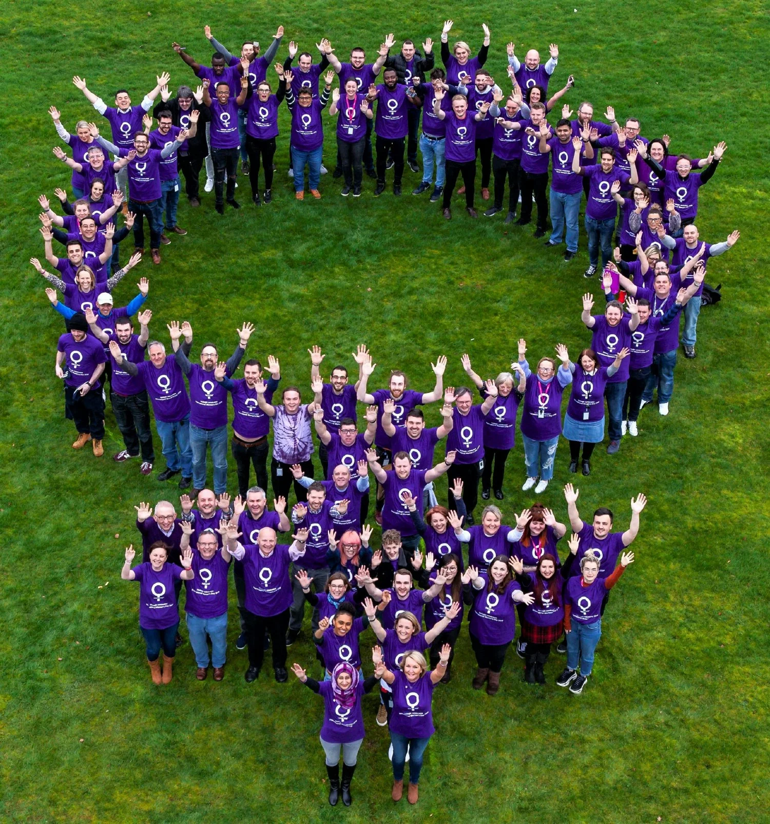 Hologic employees in Manchester, UK form our women's health symbol.