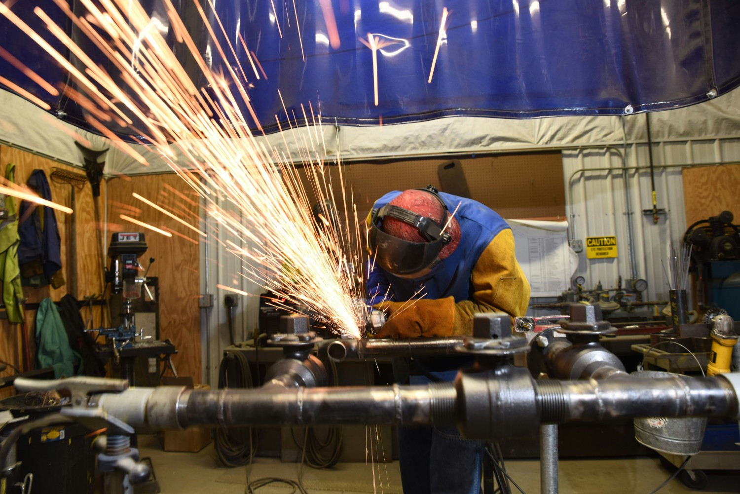 A NorthWestern Energy natural gas worker welds natural gas pipes.