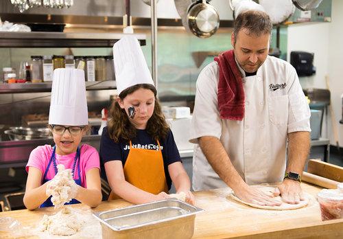 Our Chef, Nathan, with his two daughters on take your kid to work day.