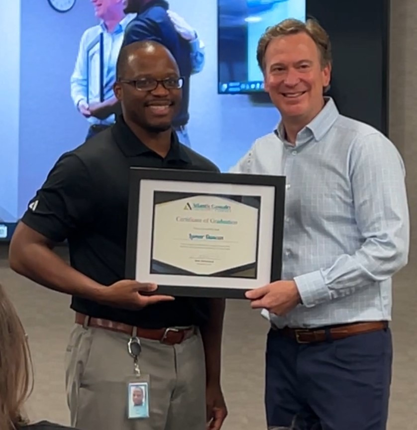 Bret Strickland CEO, awarding ACIC Leadership Academy graduation certificates. 