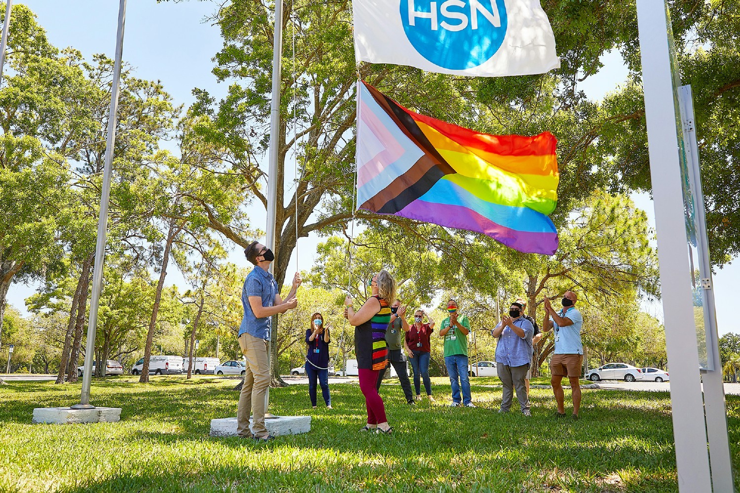 Team members raise the Pride flag at HSN headquarters in St. Petersburg, FL.
