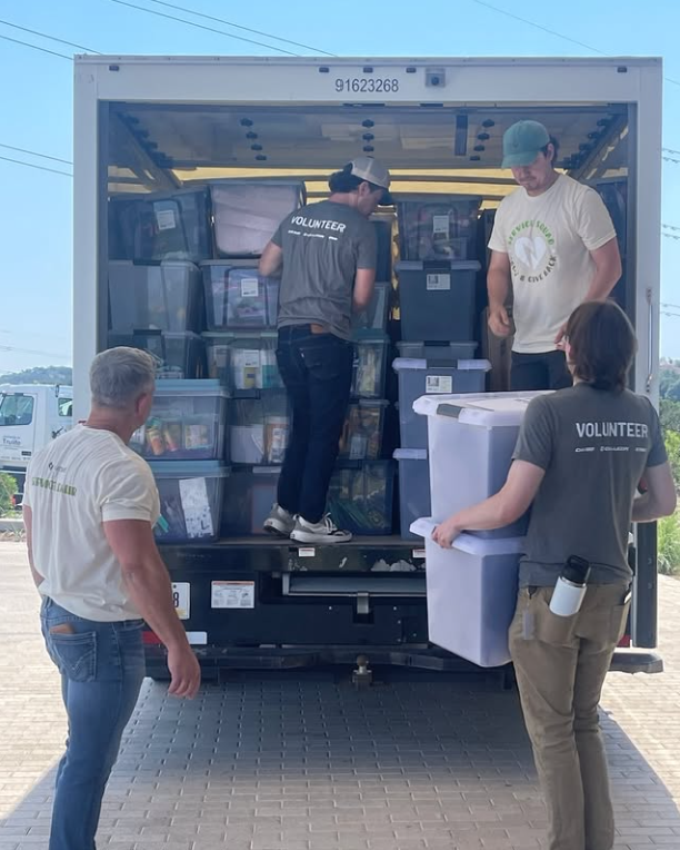Teammates put their hands together to deliver school supplies to local teachers. 
