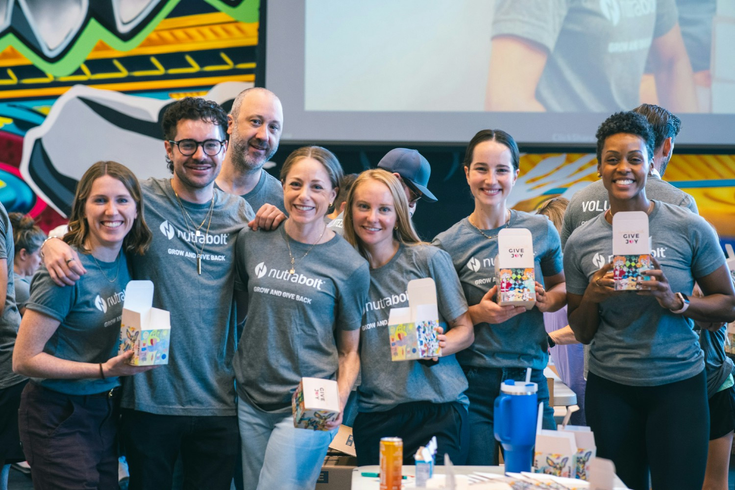Austin teammates volunteer to fill snack boxes for kids alongside Nutrabolt partners at the GiveJoy Foundation. 