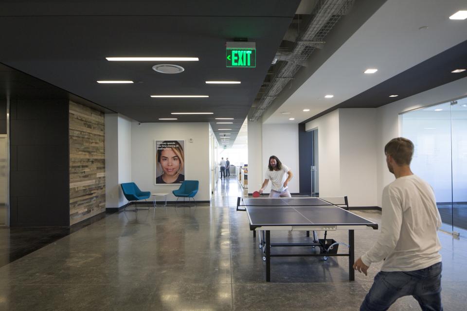 Vivint Smart Home employees enjoying a game of table tennis at the Vivint Innovation Center in Lehi, Utah.