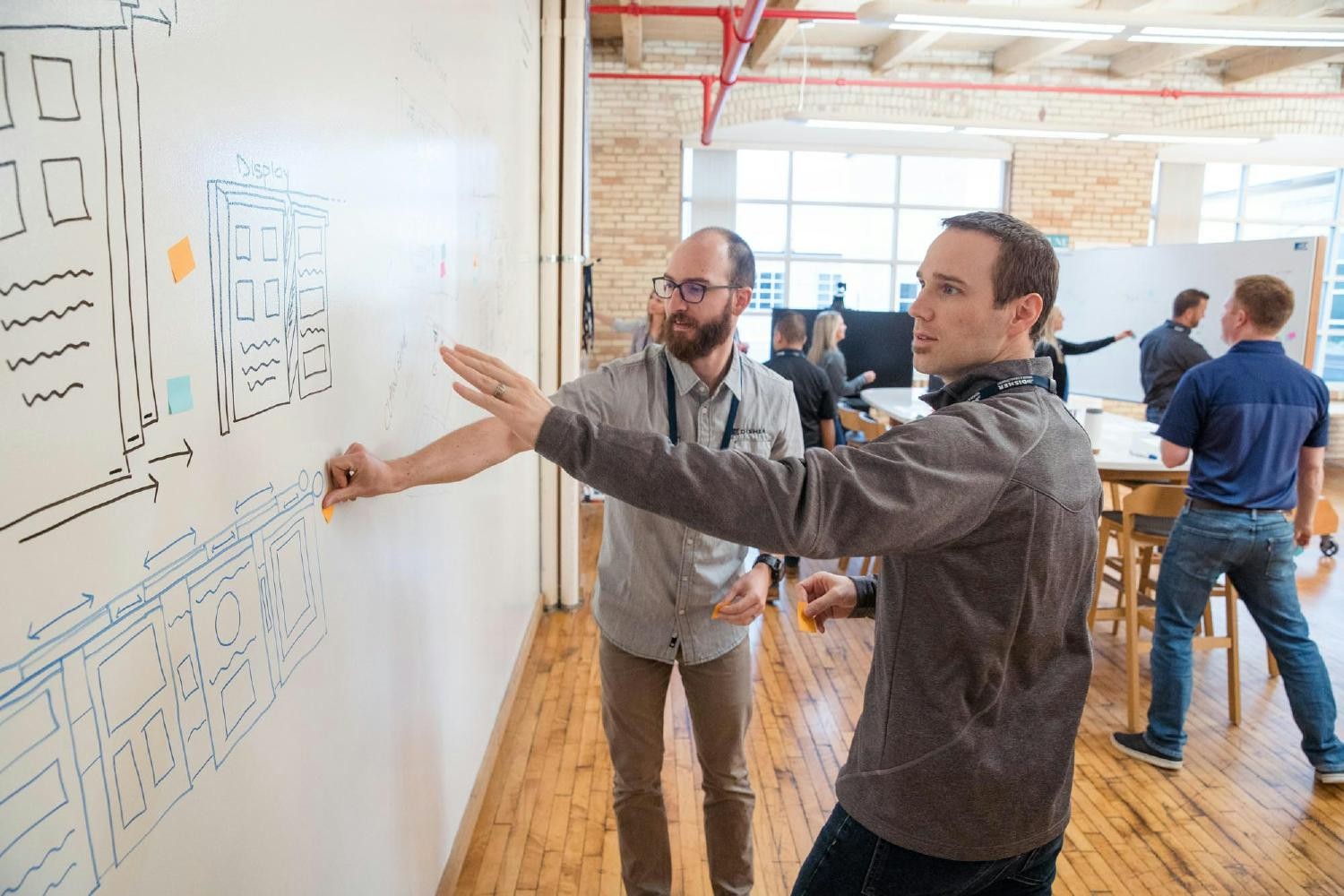 Two team members ideate together at a DISHER Whiteboard Wednesday event