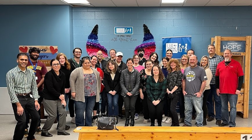 Associates volunteering time to help Feed My Starving Children