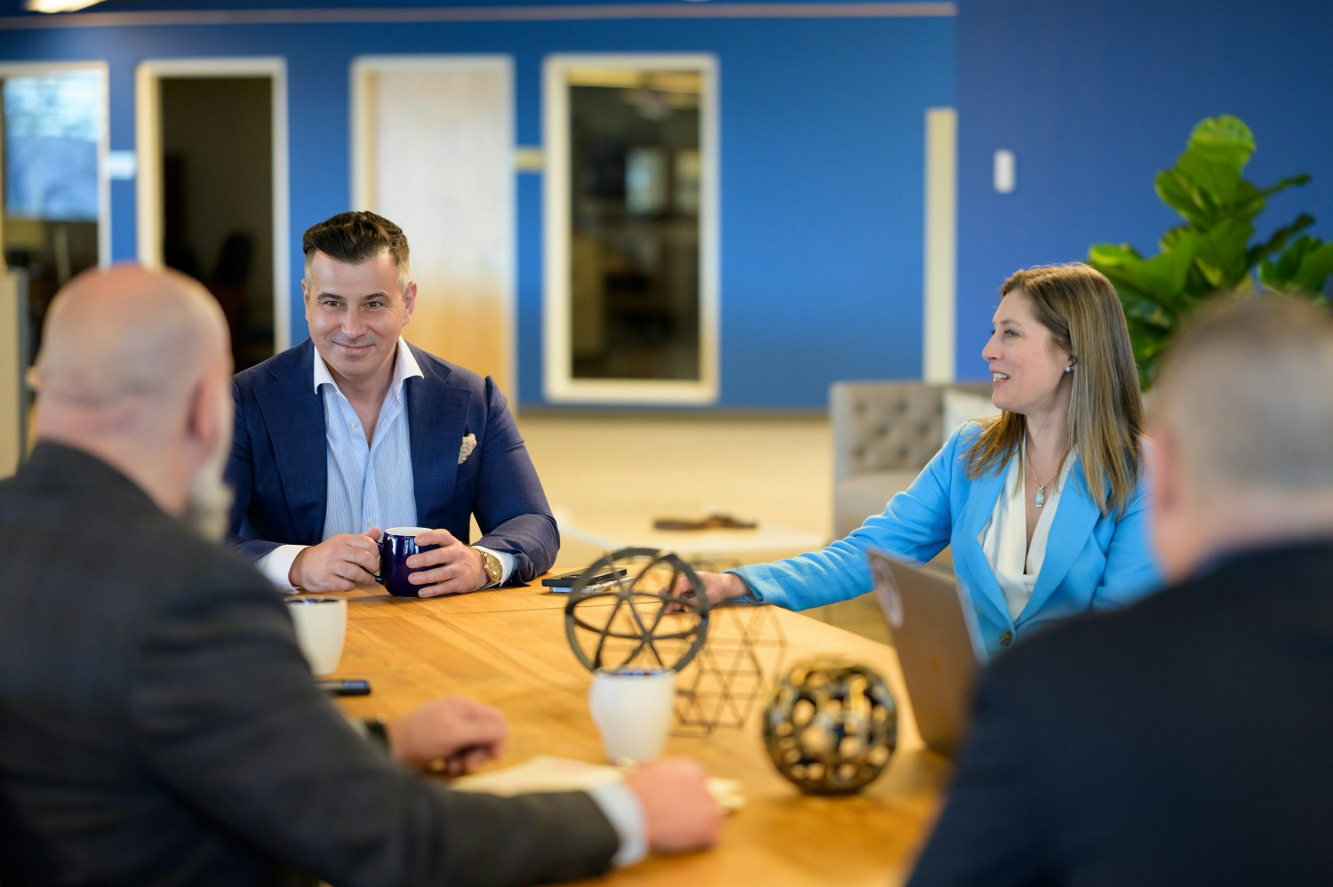 Team collaboration in action during a business meeting with President Nuno Fernandes and Provost Dr. Elizabeth Johnson.