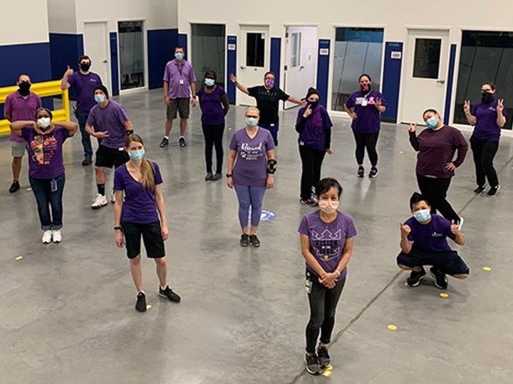 Team members join together to raise awareness of and stand up against the bullying of LGBTQ+ youth by wearing purple