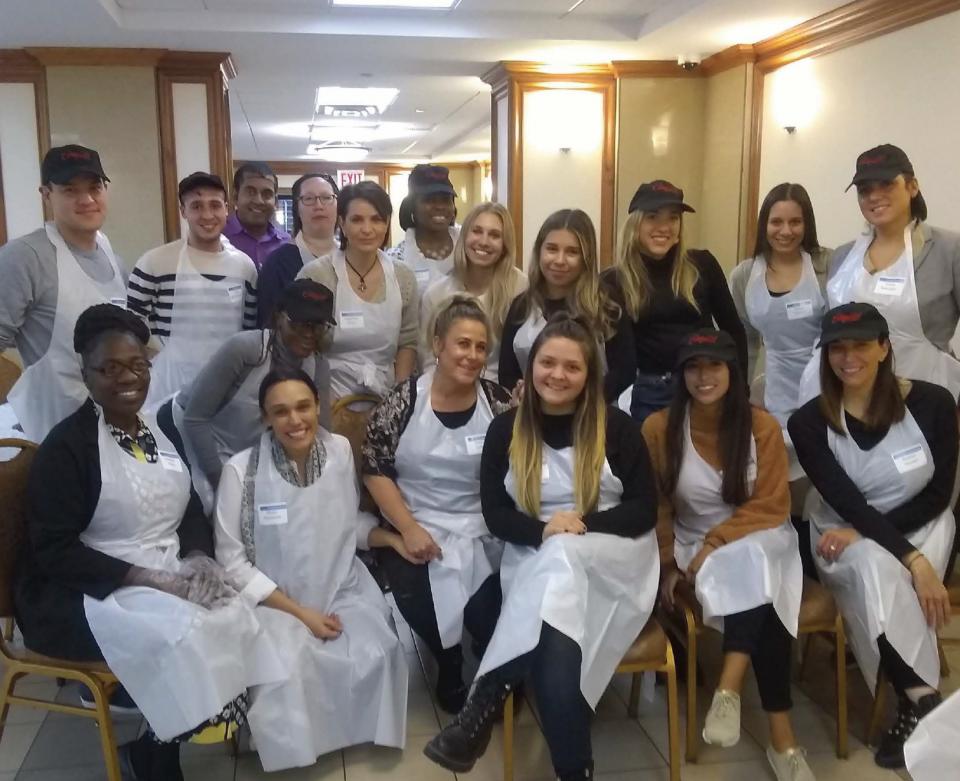 C21ers serving lunch at a senior center through our volunteer initiatives to give back in our communities.