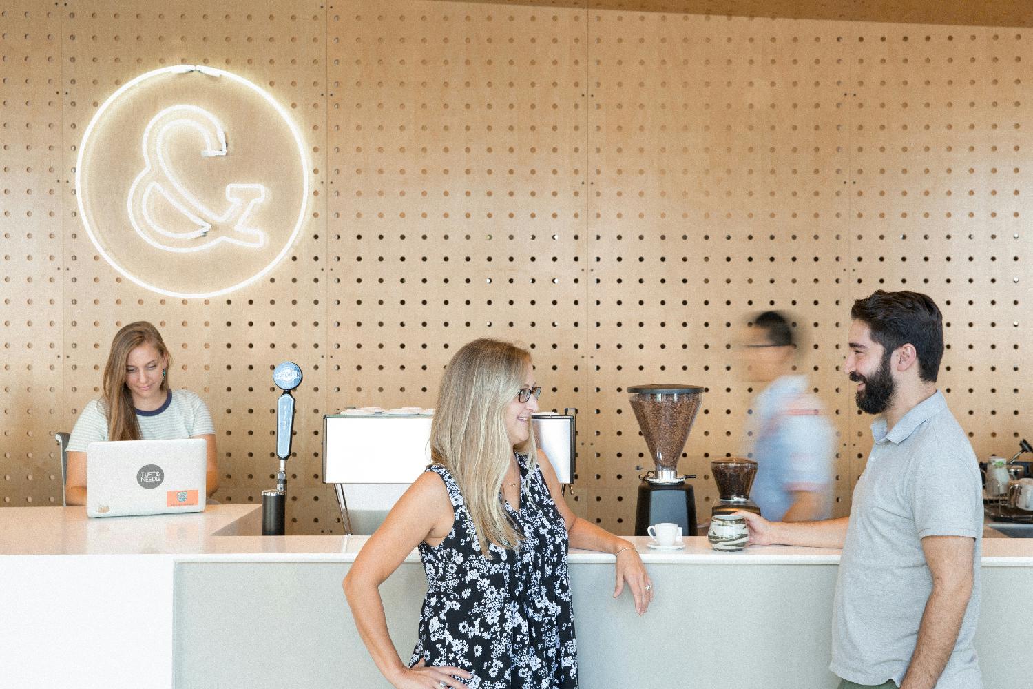 Employees catch up at the HQ coffee bar.