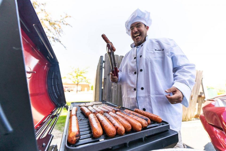 The president of Quality Logo Products put on his chef hat and made hot dogs and hamburgers for Memorial Day!