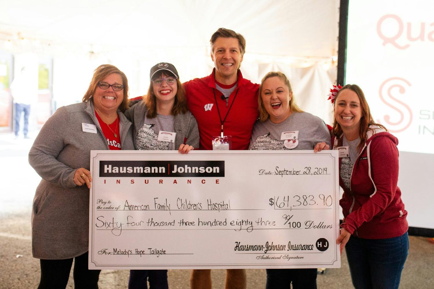 Presenting a fundraiser check for local a children's hospital (pre-covid)