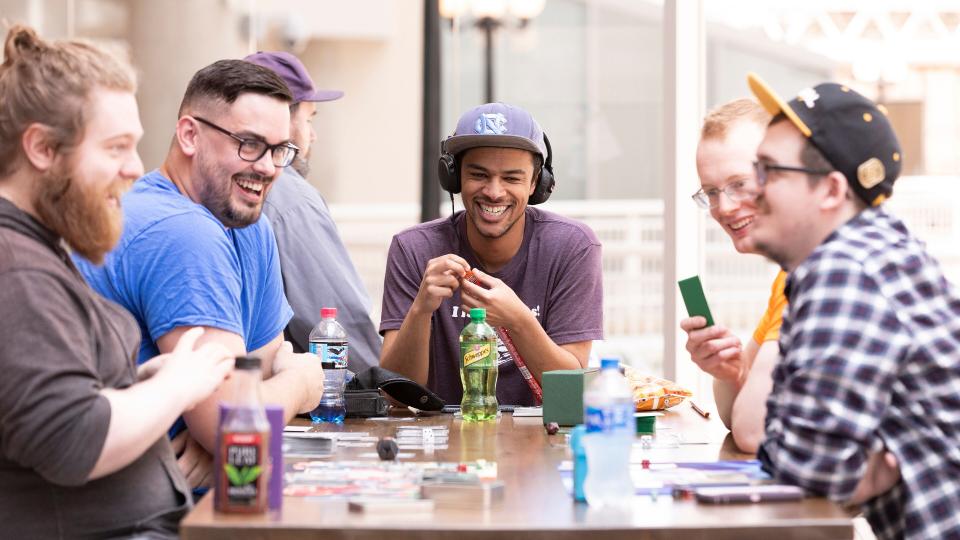 Team members enjoying a game of Magic: The Gathering, the most popular game on our marketplace