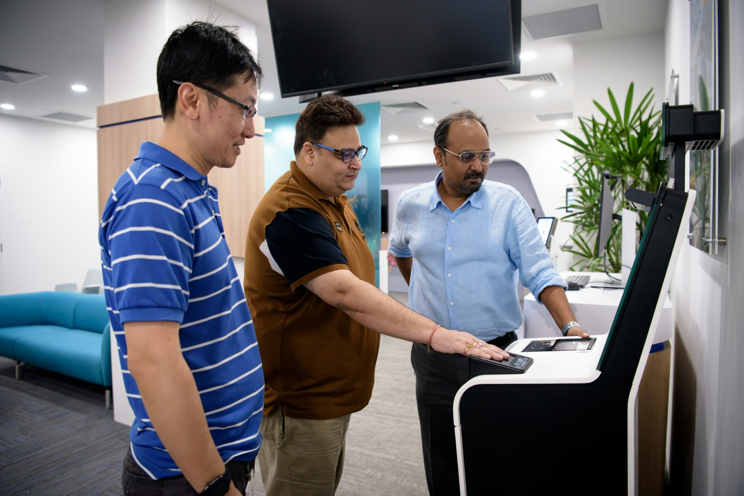Exploring innovation hands-on—team members engage with smart self-service technology.