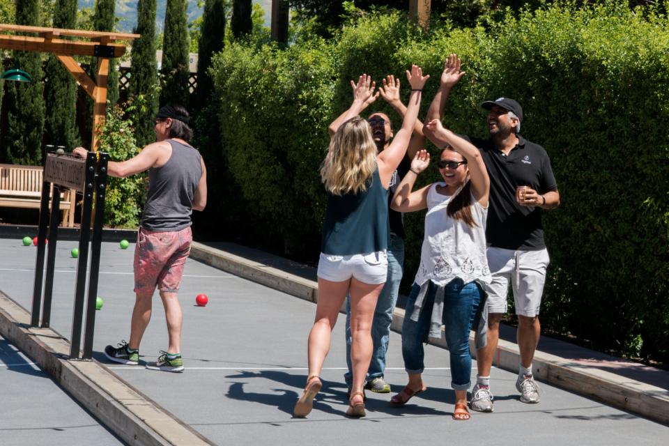 Highfive bonds together at a team offsite playing bocce ball