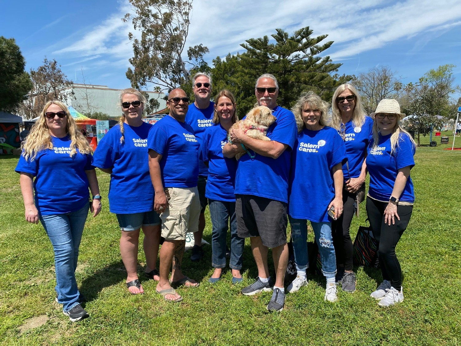 Employees volunteering at RescueCon, which promotes animal rescue & adoption. One even went home with a dog!