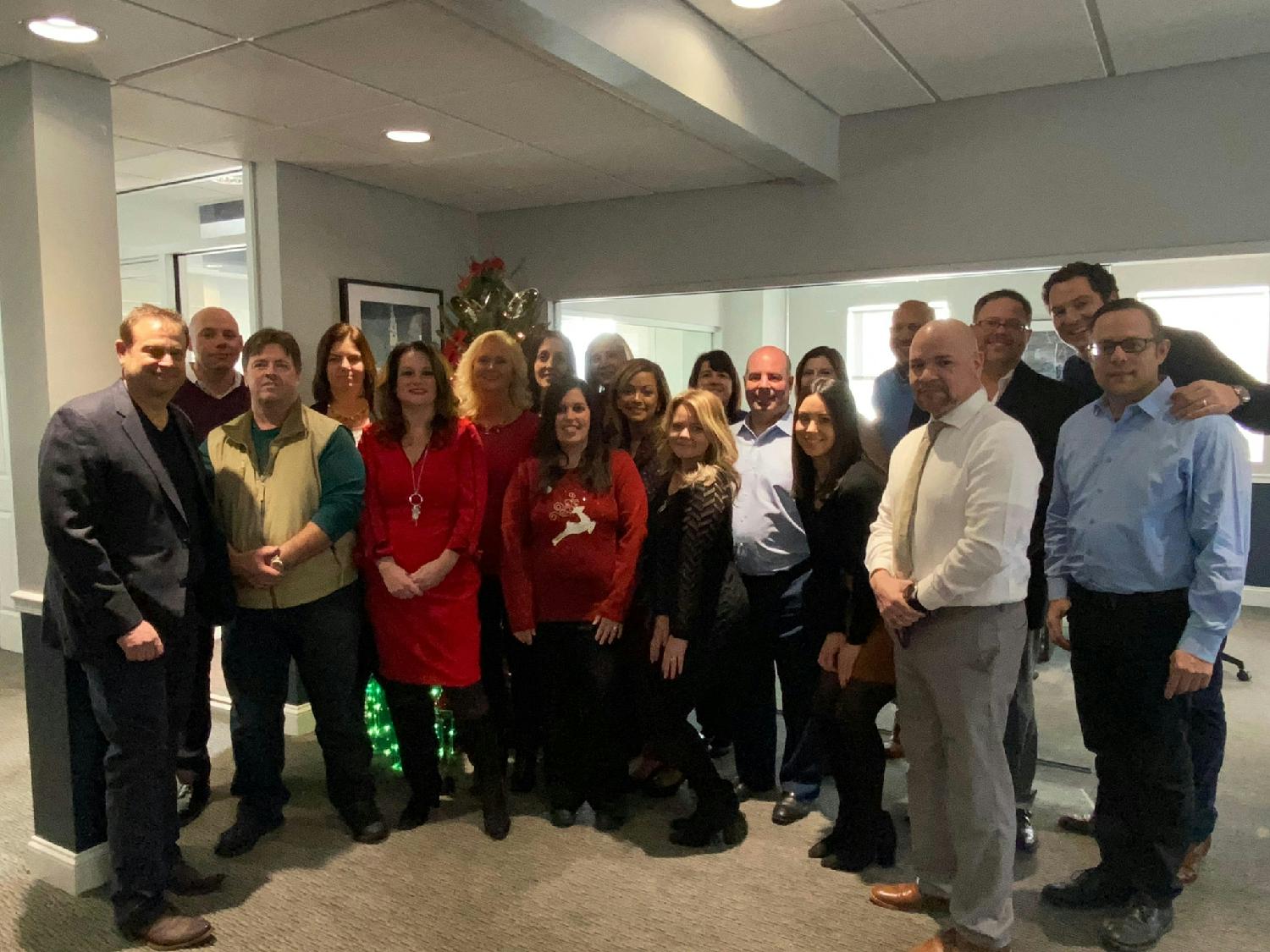 Executive leaders Tom George and Chris Jones celebrate the holidays with branch employees in Rhode Island.