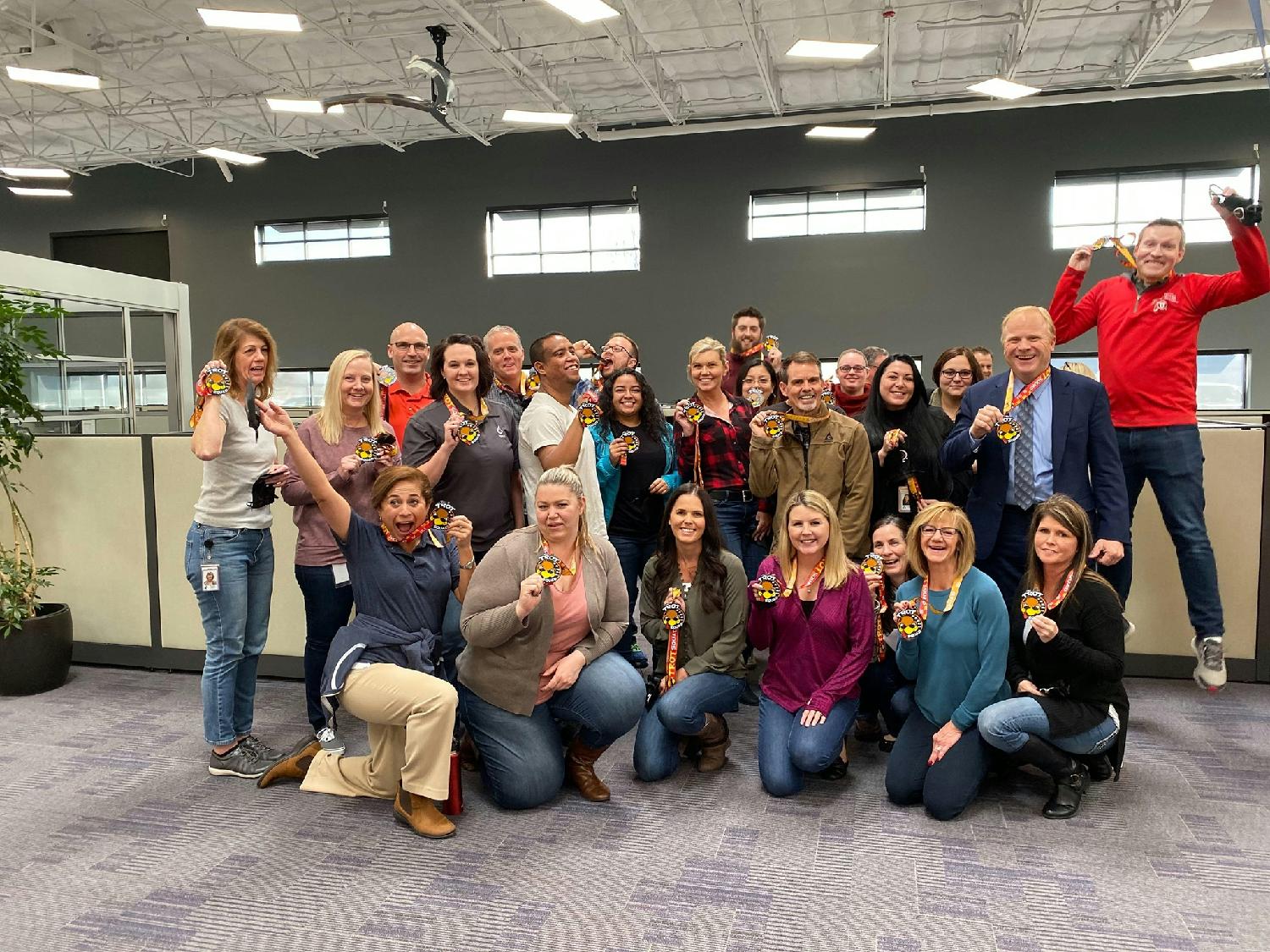 Team members showing off their Turkey Trot medals. PRMI regularly sponsors employee health and wellness initiatives.