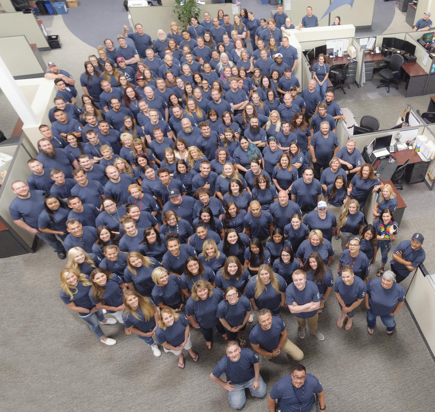 Corporate employees show of PRMI pride by wearing matching company shirts during spirit week.