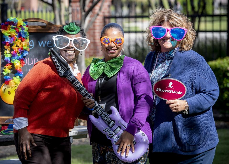 Employees get silly at the selfie station during Judestock—an on-campus lunchtime concert series for employees to enjoy Memphis music and some fun, relaxed social time with colleagues.