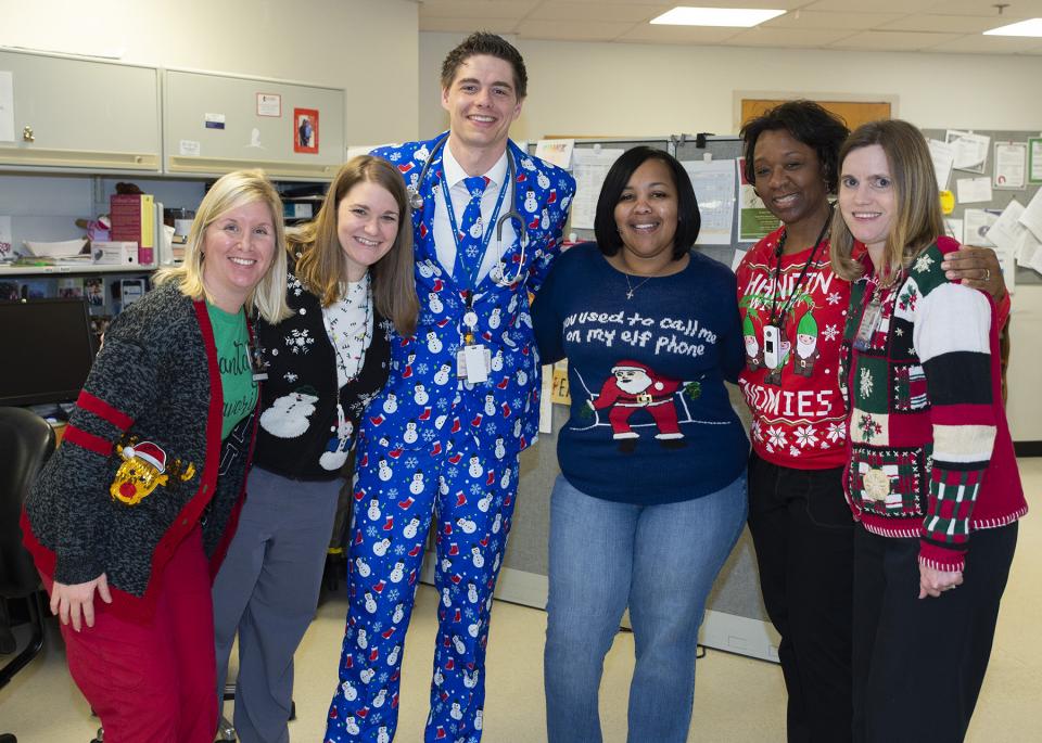 St. Jude staff members show off their fashionable sweaters—and suit—as part of the annual Employee Holiday Sweater contest.
