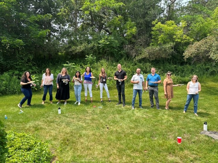 Employees gathered outside the office for an ice cream social event