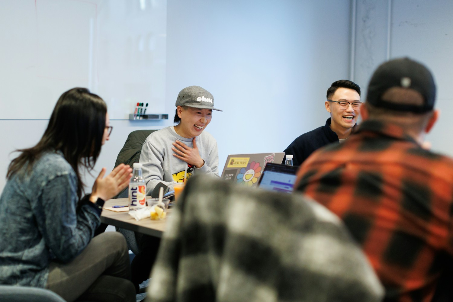 Teams often meet in our global offices' collaboration spaces for a quick stand-up or just to catch up with each other.