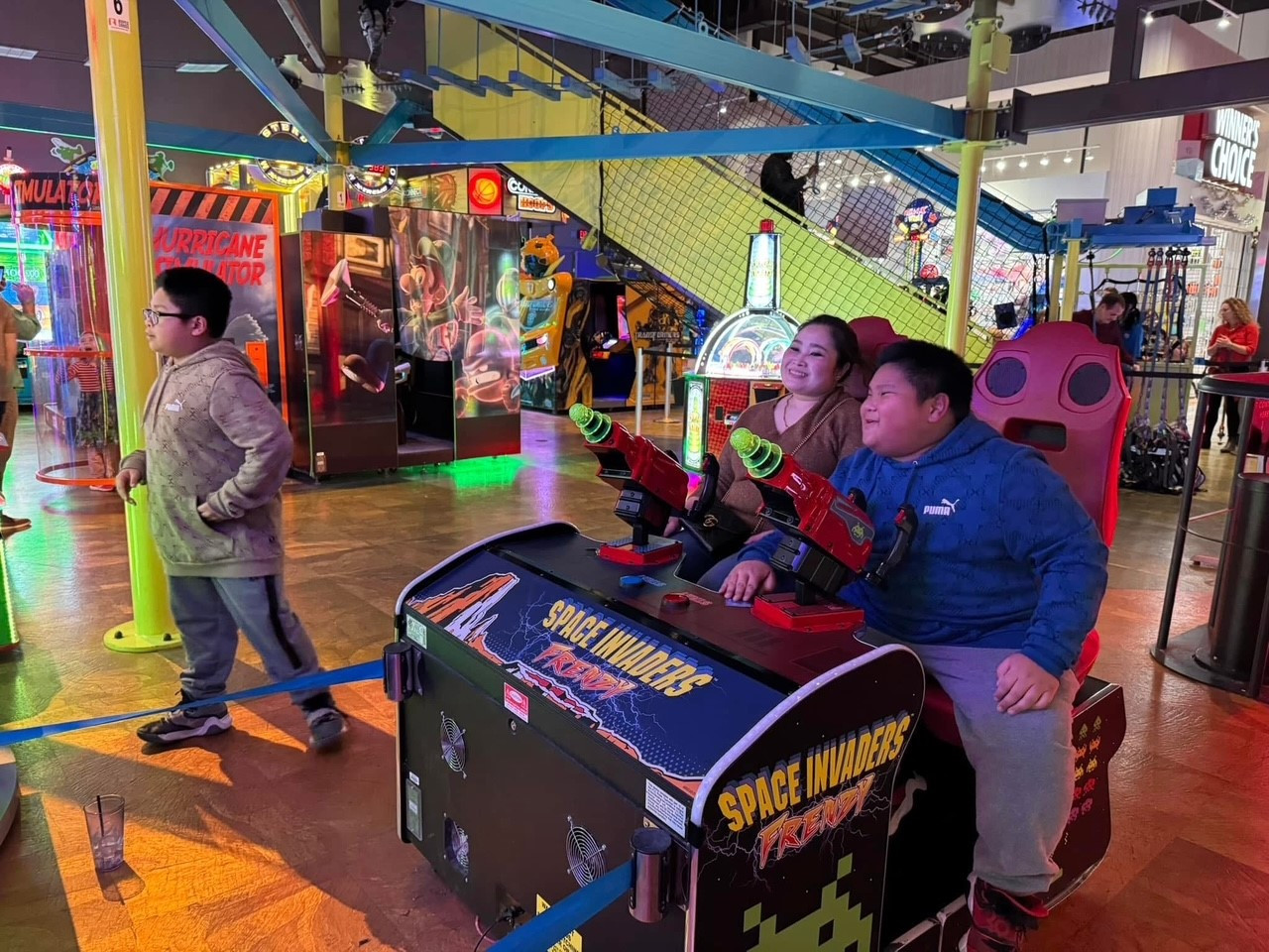 In 2024, we held our annual family holiday party at Main Event, celebrating with bowling, laser tag, and arcade games.