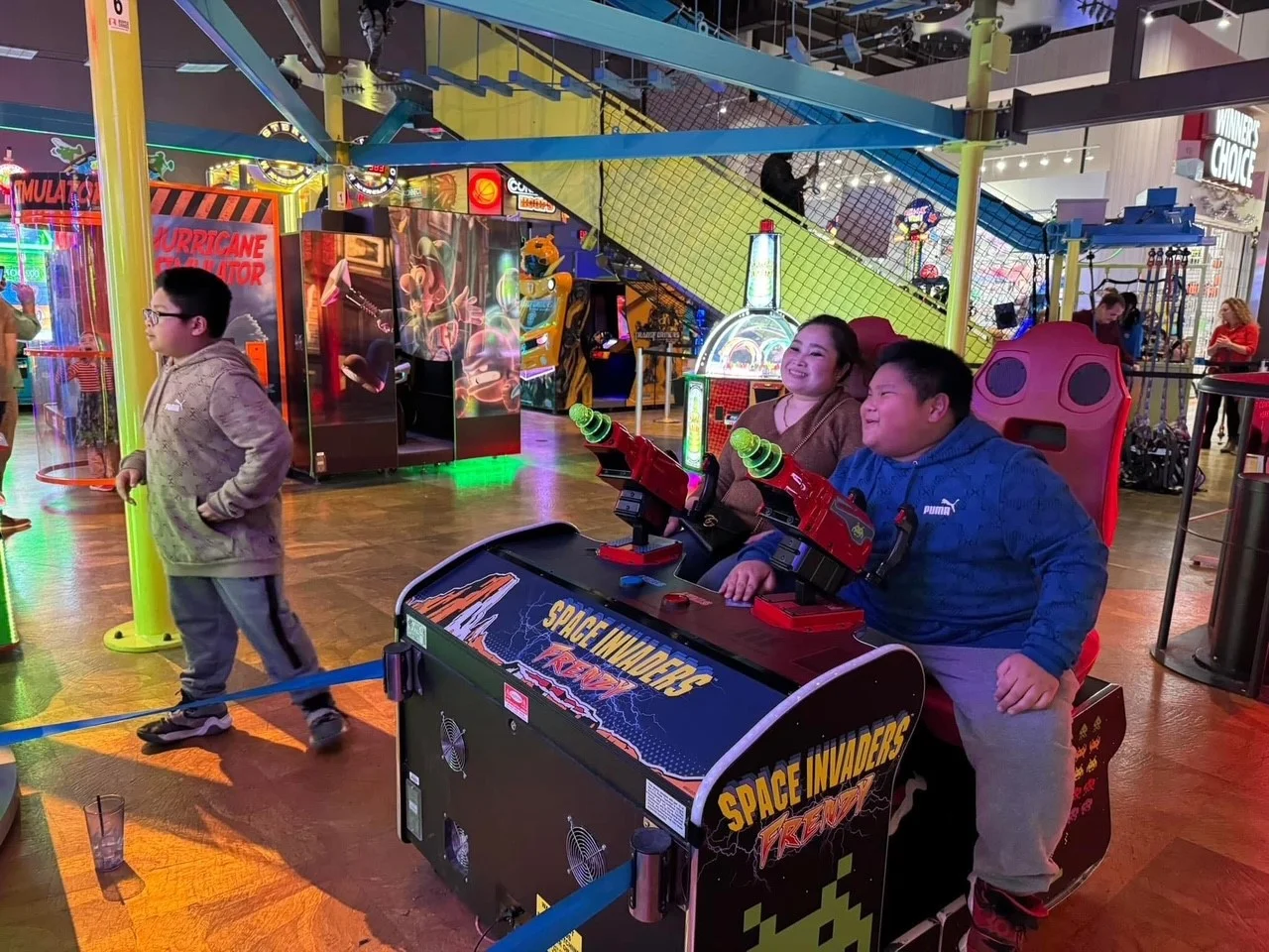 In 2024, we held our annual family holiday party at Main Event, celebrating with bowling, laser tag, and arcade games.