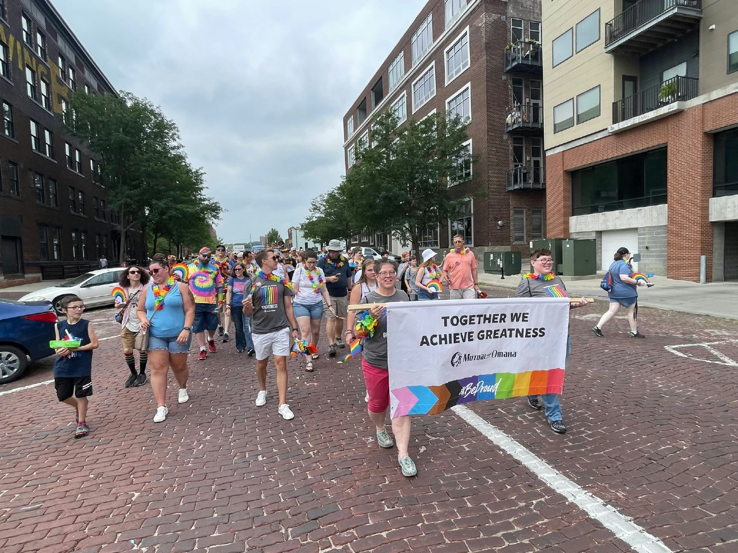 EMPLOYEES & FAMILIES SUPPORT EACH OTHER BY WALKING IN THE HEARTLAND PRIDE PARADE TO PROMOTE INCLUSION & EQUALITY