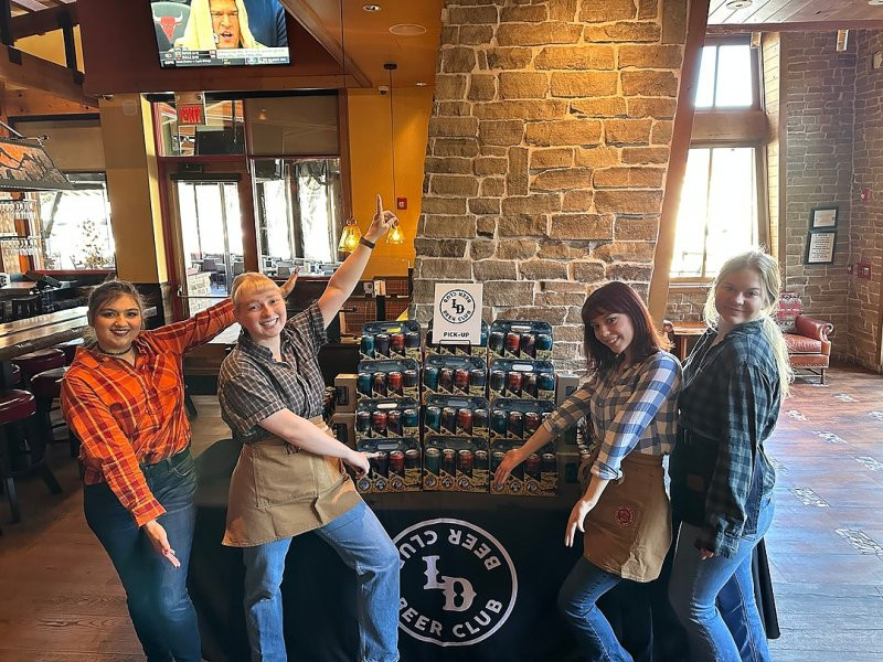 Servers showcase the Lazy Dog Beer Club with gorgeous display.