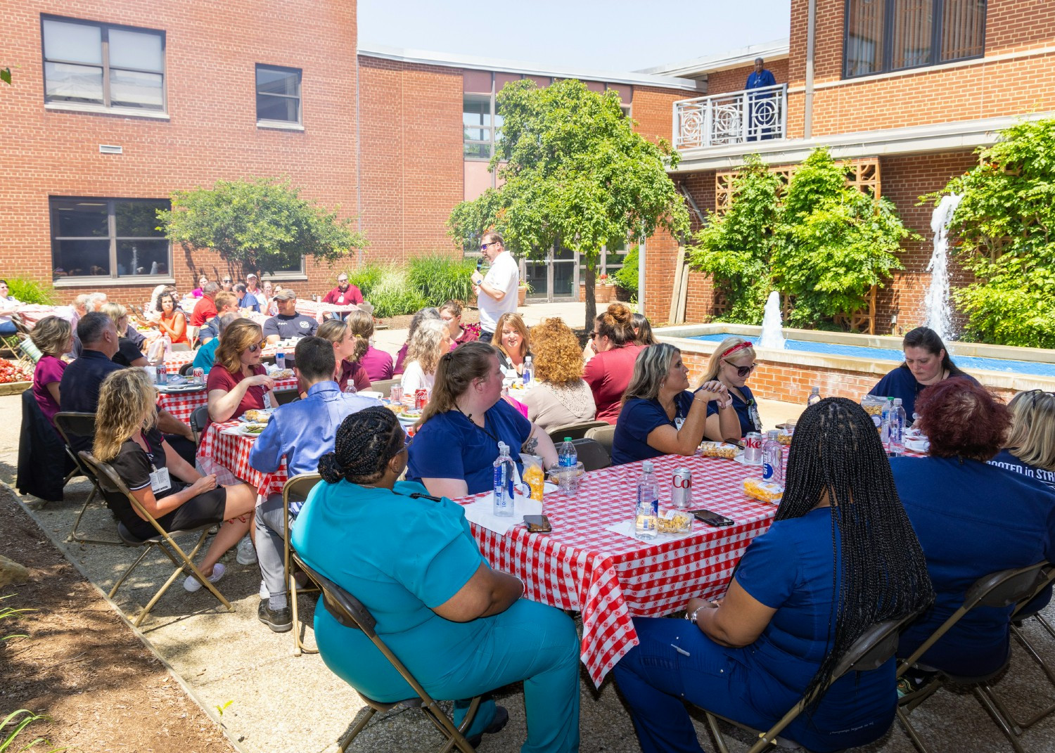 Staff enjoying the company picnic while our CEO delivers announcements.