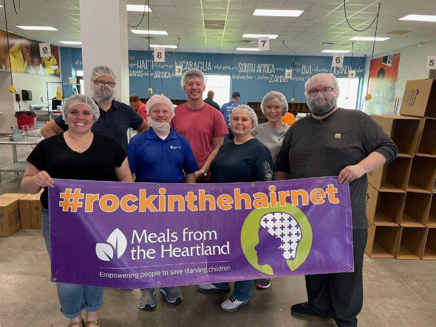 TEAM COMING TOGETHER TO VOLUNTEER AT THE MEALS FROM THE HEARTLAND PROGRAM. 