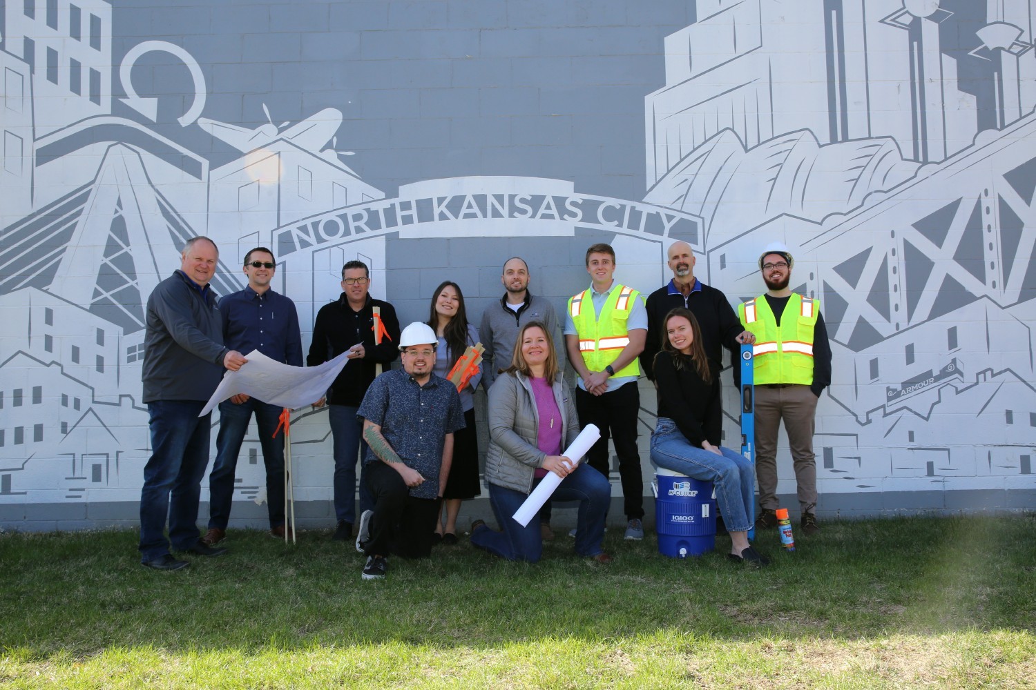 Members of the North Kansas City office pose near a local mural. 