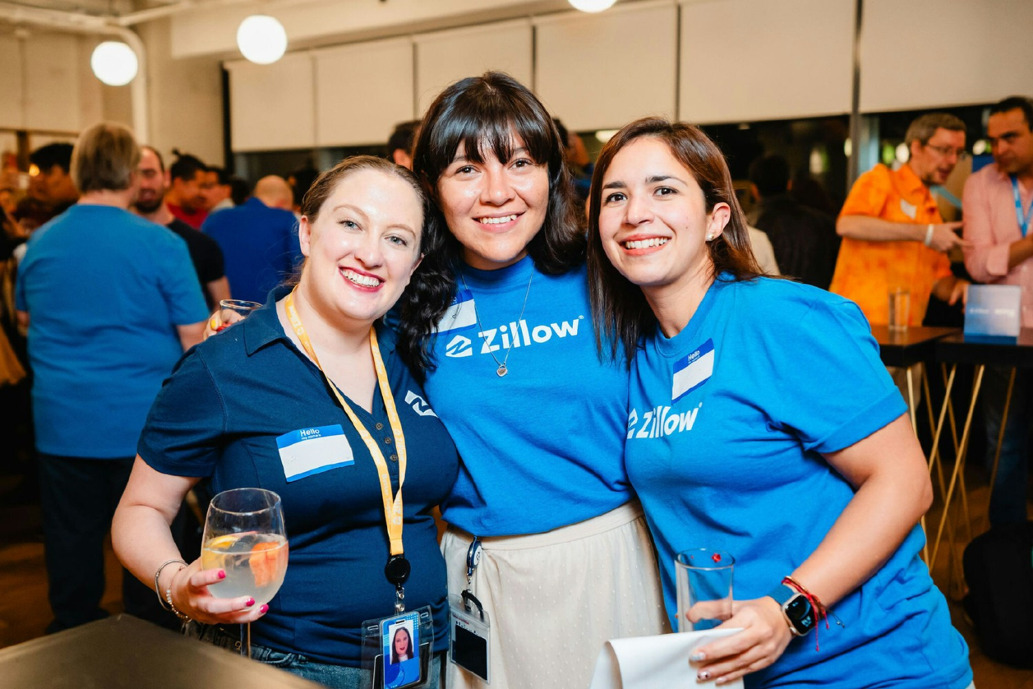 Employees attend a Zillow networking event.