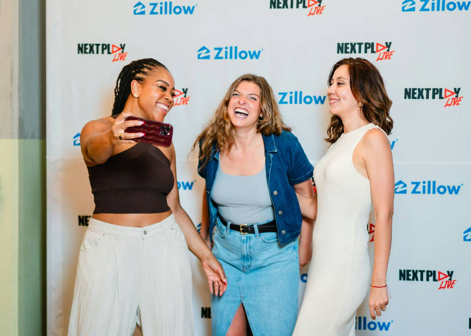  Employees taking a candidate selfie at a Zillow event. 