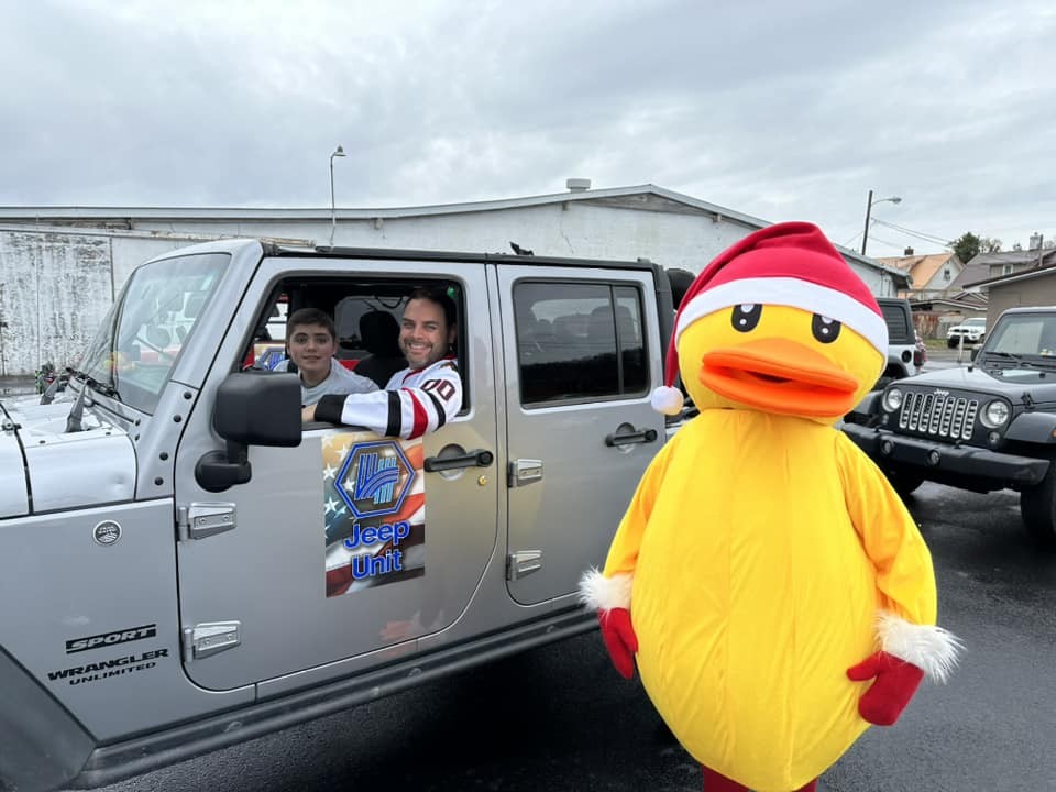 Staff are encouraged to participate in local events.  Pictured is a member of the Jeep club during a local parade.