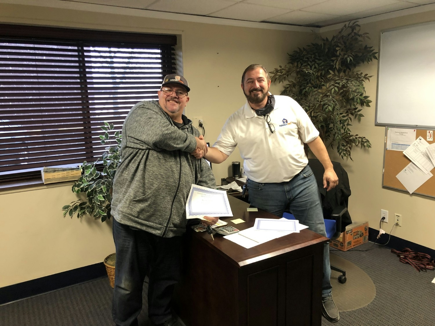 Handyman Russ A. Proudly receiving his HP Craftsmen Certification from MGR Joe K, which he recently passed Dec 2021. 