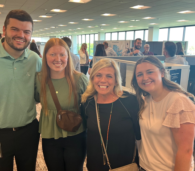 Many interns receive full-time offers after graduating. Pictured is an HR manager with her current and former interns. 