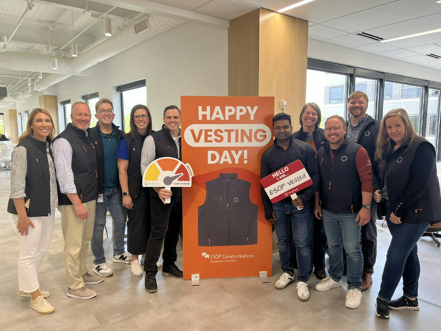 Team members celebrating receiving a vest from our CEO as they become vested in ITA Group’s ESOP.
