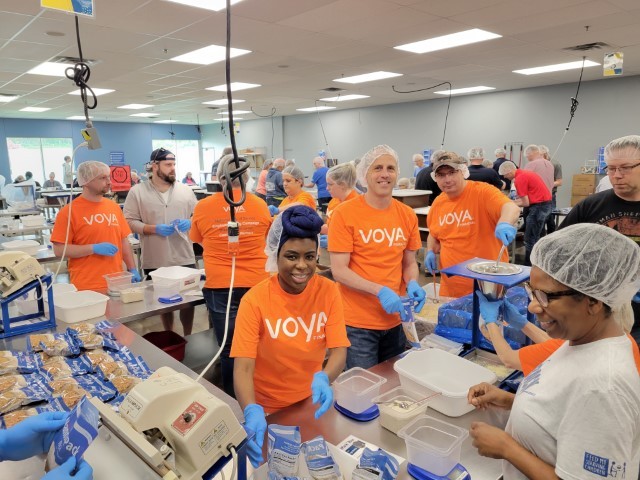Employees volunteering with Feed My Starving Children near Minneapolis.