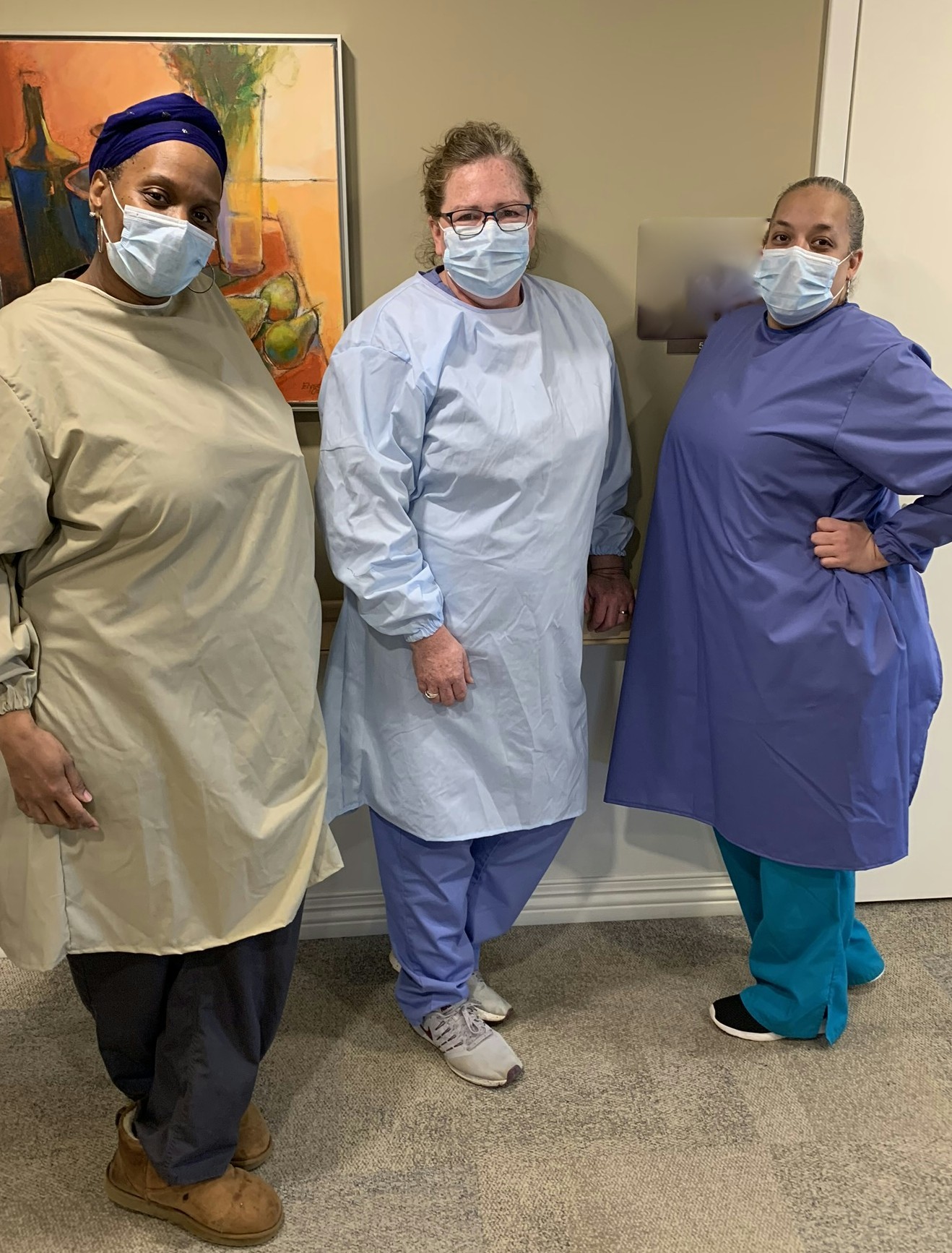 Nurses modeling the gowns made by the Amish folks.