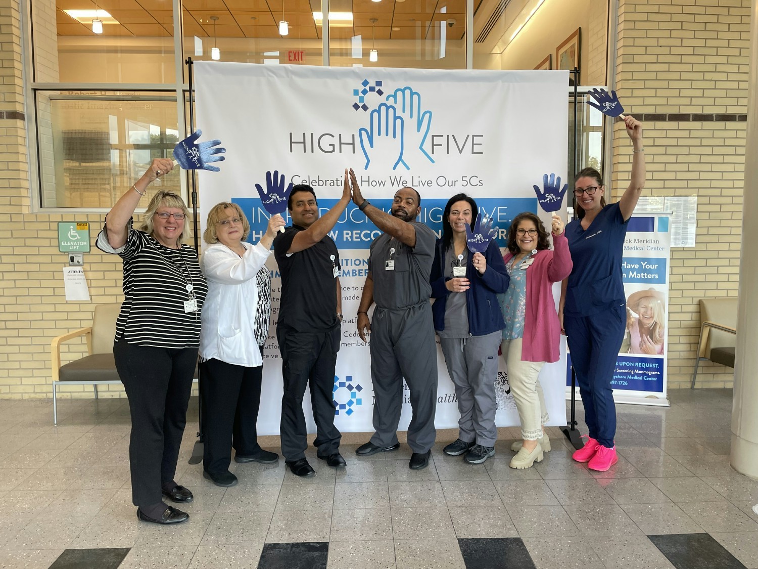 Team members celebrate the launch of our new recognition platform, High Five!