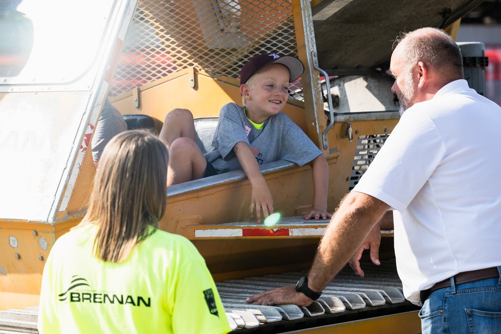 Brennan teaching local children about amphibious construction equipment 