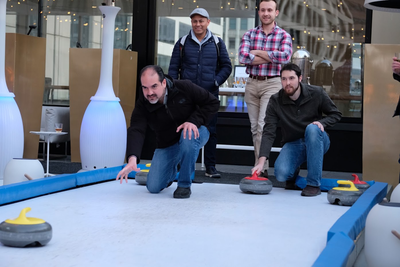 Teams compete in a rooftop curling competition.